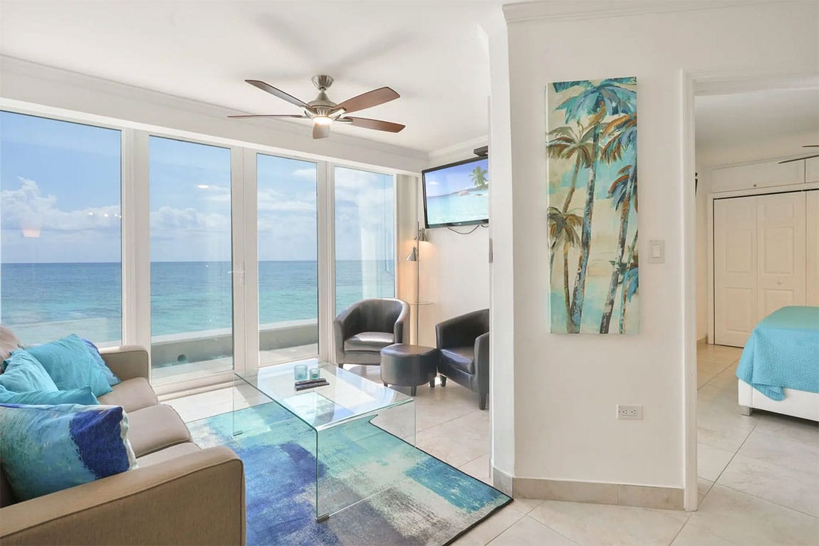 Large windows at Cayman Reef Resort frame the picturesque views of the Caribbean Sea.