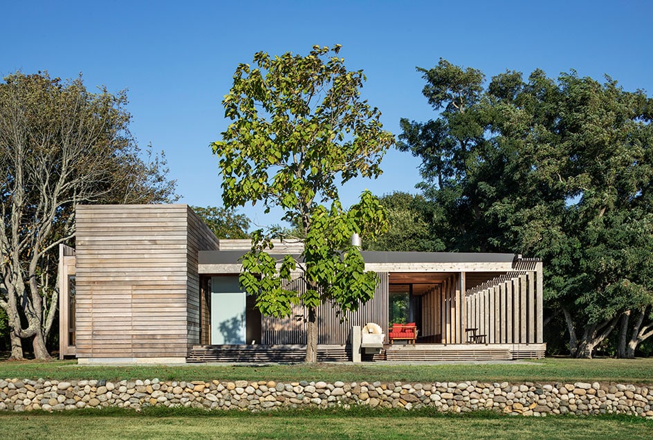 Instead of blocking off the home with a fence, privacy is maintained by a solid wall of trees